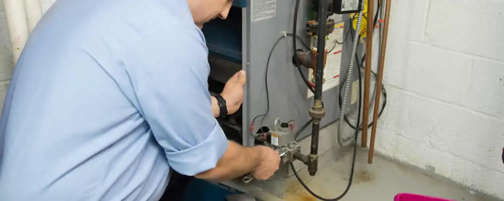 Furnace repair technician inspecting and servicing a home heating system in Mountain View, CA