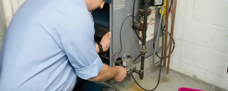 Furnace repair technician inspecting and servicing a home heating system in Mountain View, CA