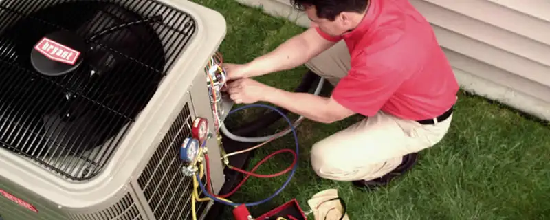 HVAC technician servicing an outdoor air conditioner unit in Mountain View, CA