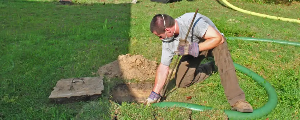 Septic pumping technician servicing a residential septic tank in Mountain View, CA
