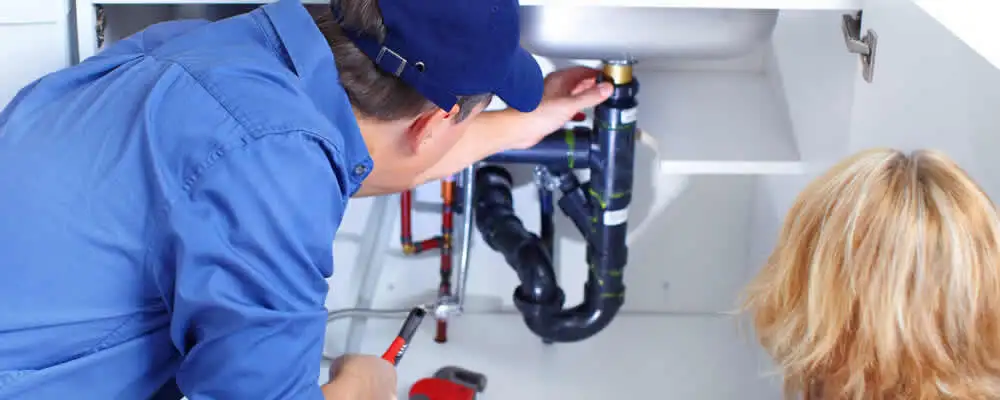 Plumber repairing under-sink drain pipes and fittings in Mountain View, CA